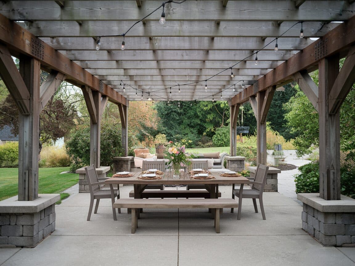 Covered pergola patio with outdoor dining table and string lights